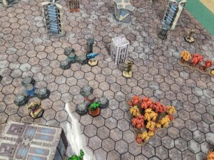 A top-down shot of a Battletech game. Visible from left to right: Ostsol, HIerofalcon (top), Assassin (bottom), Charger, Ostscout.